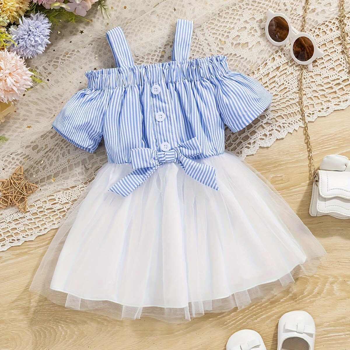 Adorable baby girl wearing a cute and playful summer stripe sundress perfect for playtime