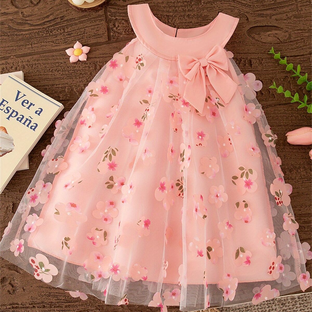 Adorable little girl twirling in a beautiful rosebud garden floral print dress perfect for weddings or a casual day out