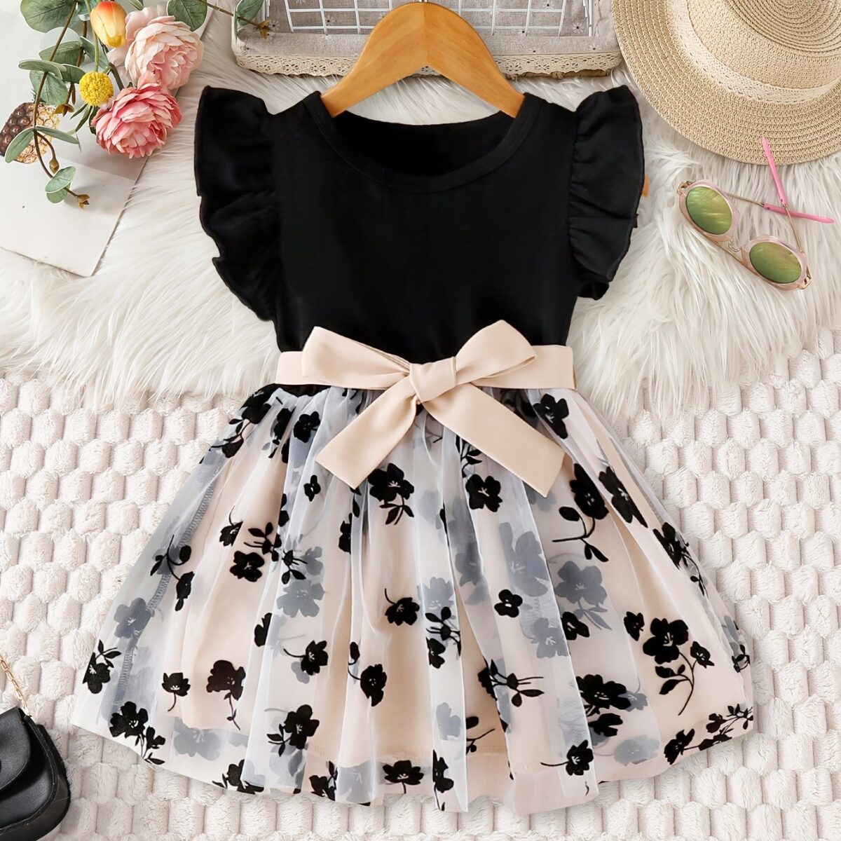 Adorable little girl twirling in a vibrant Summer Bloom floral print dress from Newness perfect for summer