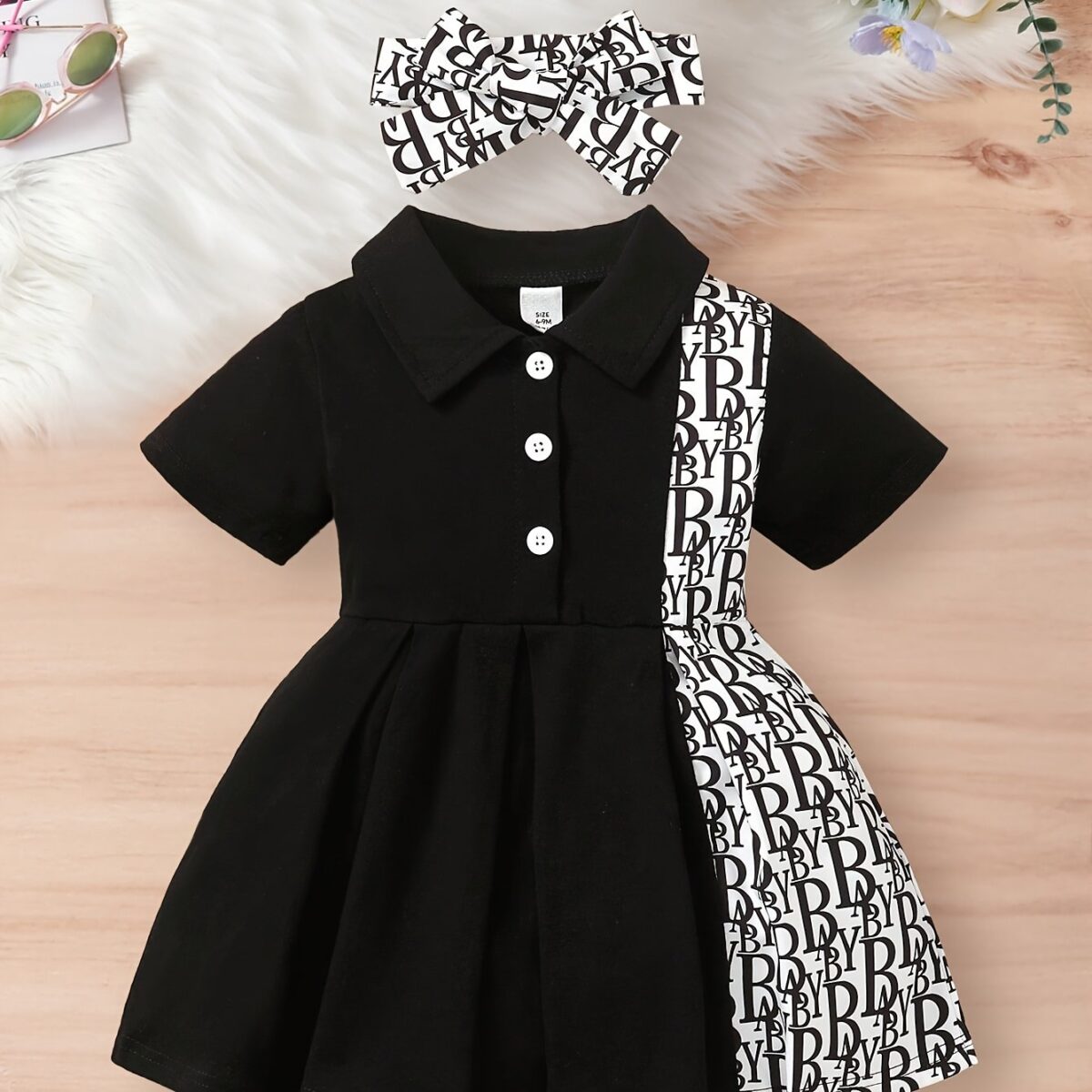 Adorable little girl wearing a stylish and comfy Newness summer letter print dress perfect for a playdate